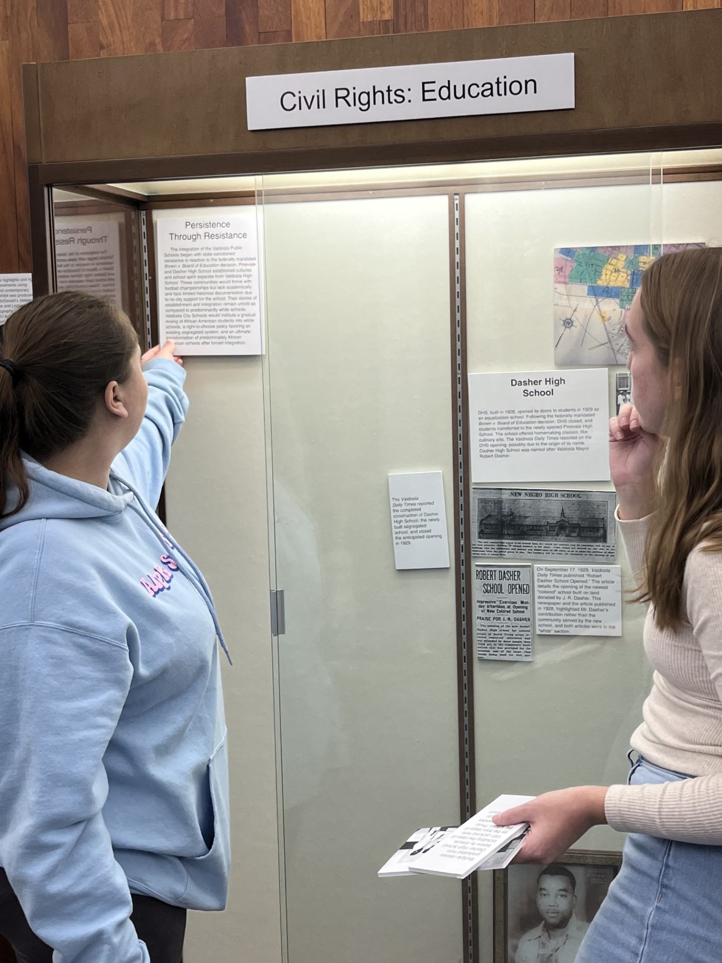 Two women standing in front of the civil rights education display